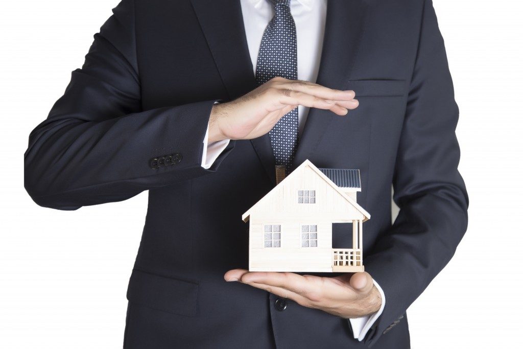 Man holding a house model