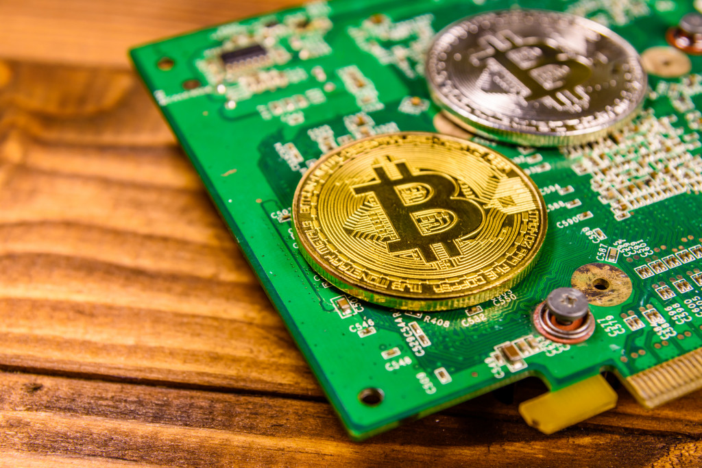 Bitcoin and circuit board on a wooden table